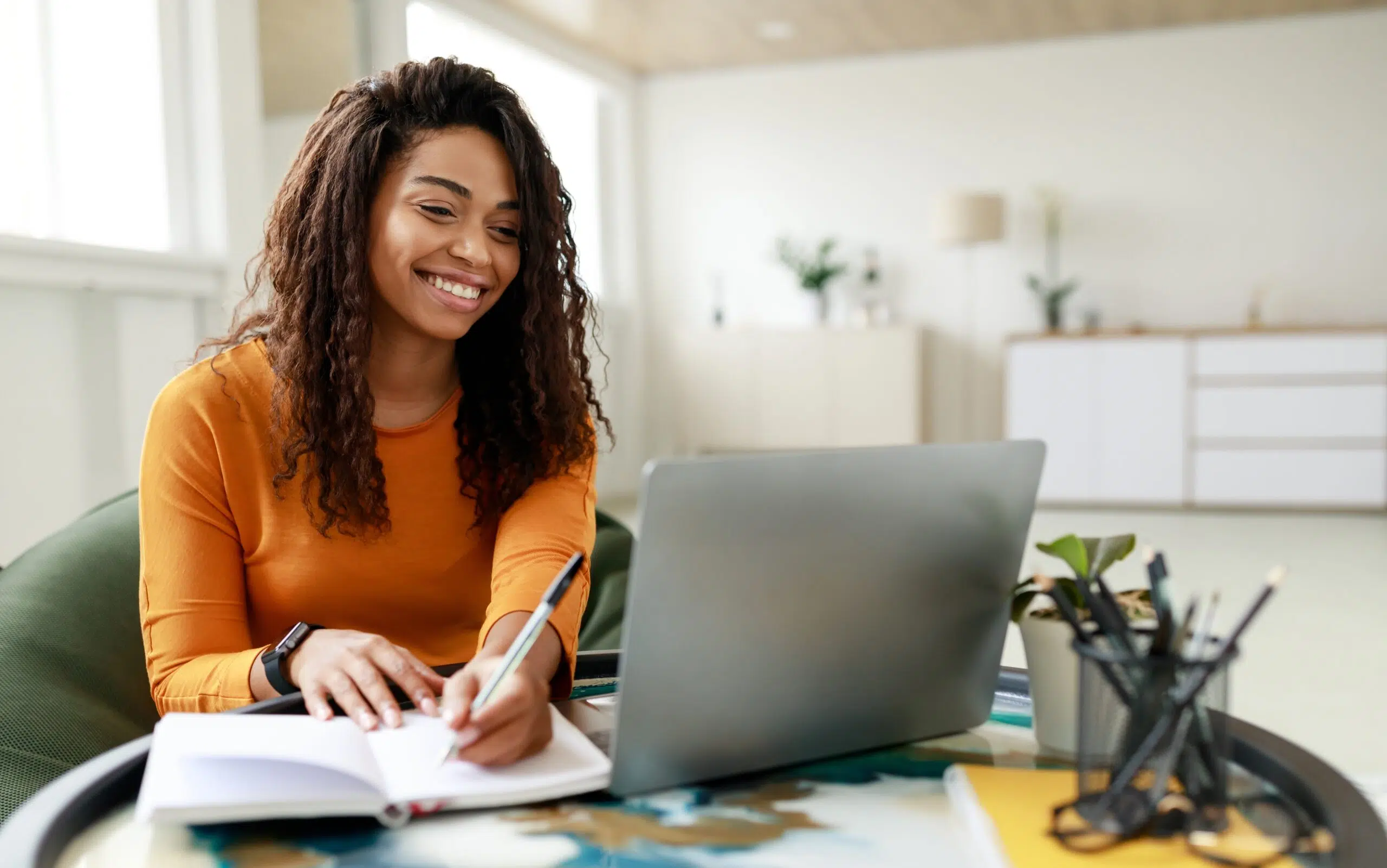 Smiling,Young,African,American,Woman,Sitting,At,Desk,Working,On
