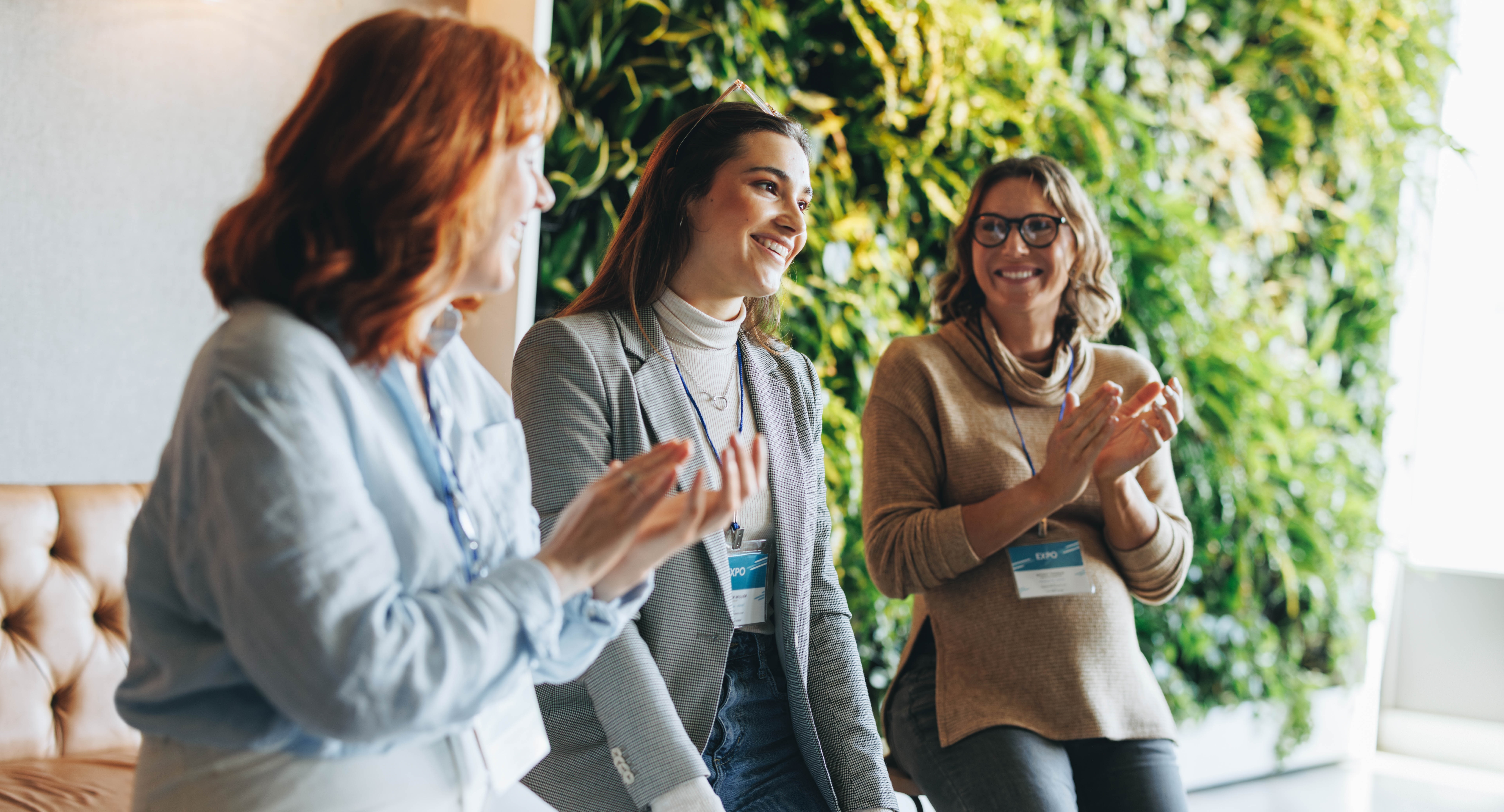 Business,Women,Applaud,And,Smile,During,A,Successful,Meeting,In