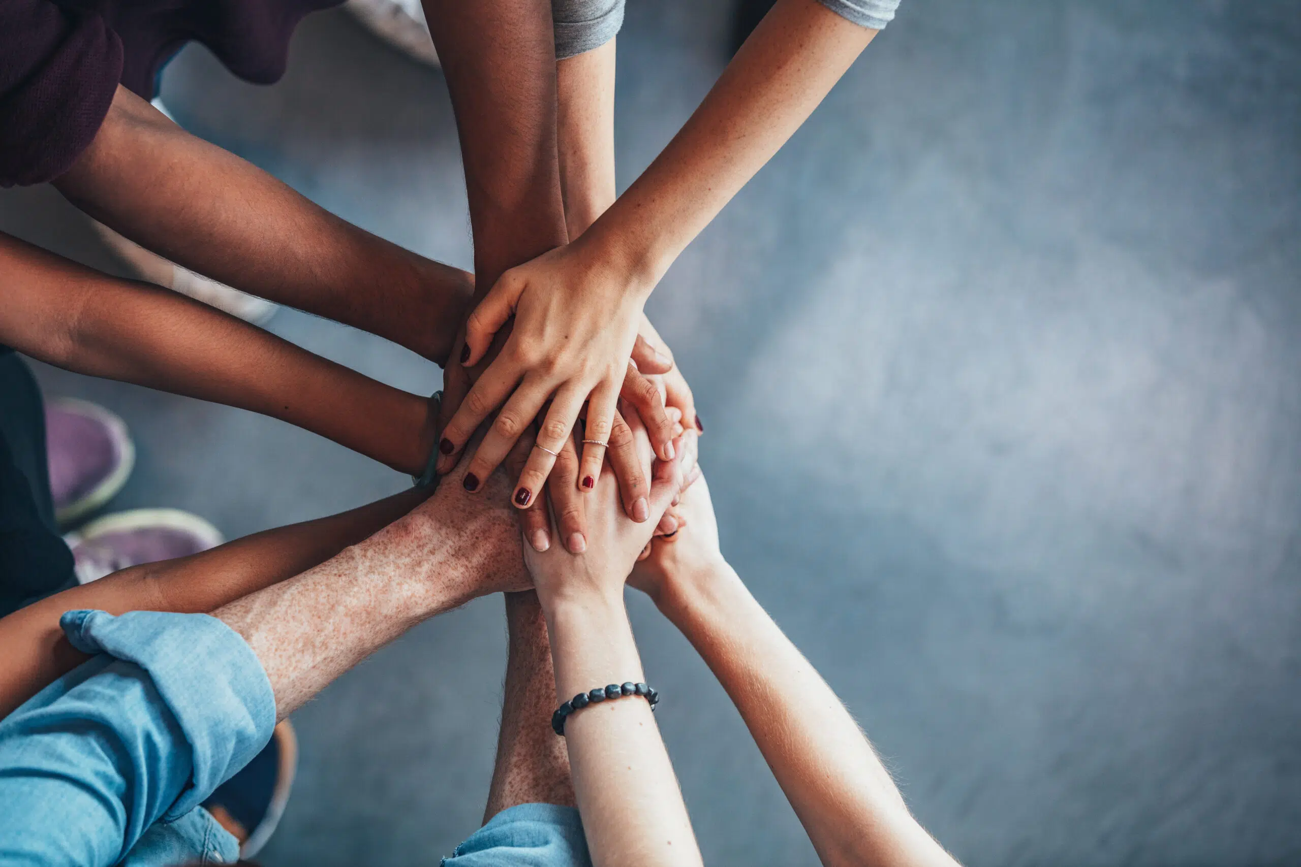 Close,Up,Top,View,Of,Young,People,Putting,Their,Hands